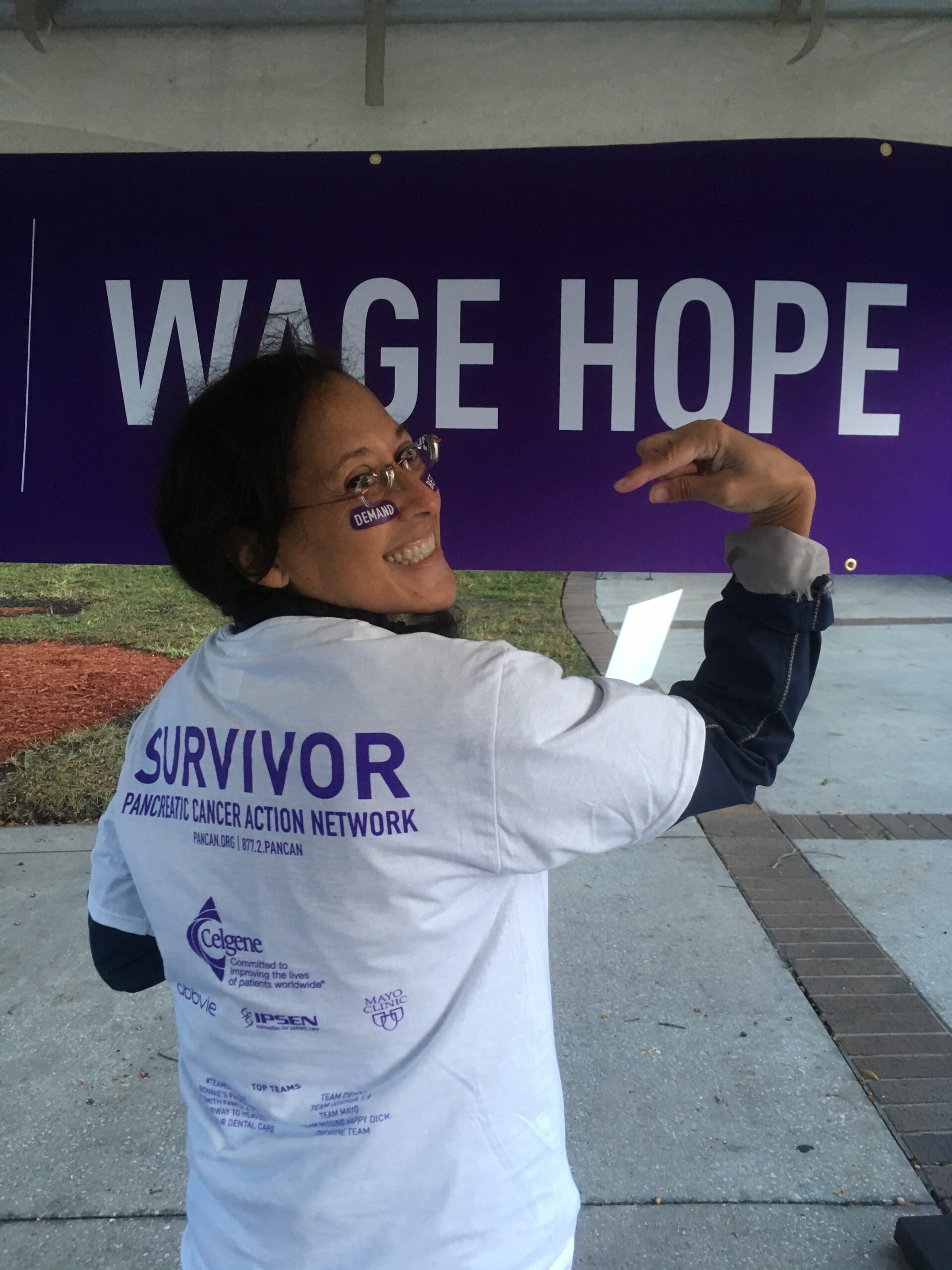 Dr. Yvette Colón standing strong as a survivor of Pancreatic Cancer and taking part at a PanCan event.