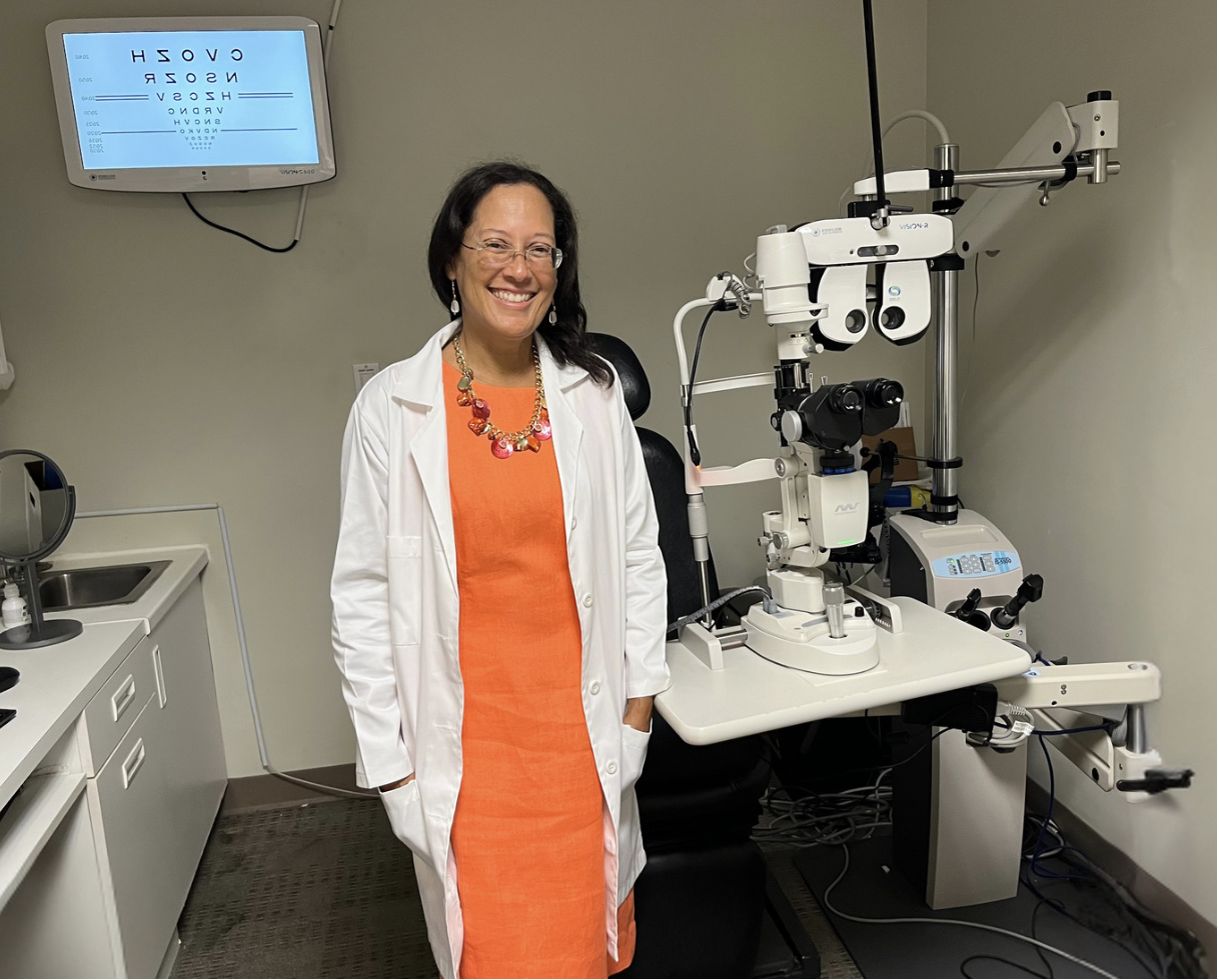 Dr. Yvette Colón standing in an eye exam room.