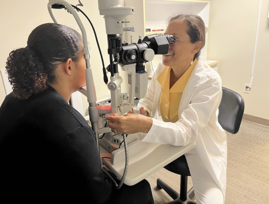 Dr. Yvette Colon performing a slit lamp exam on a patient.