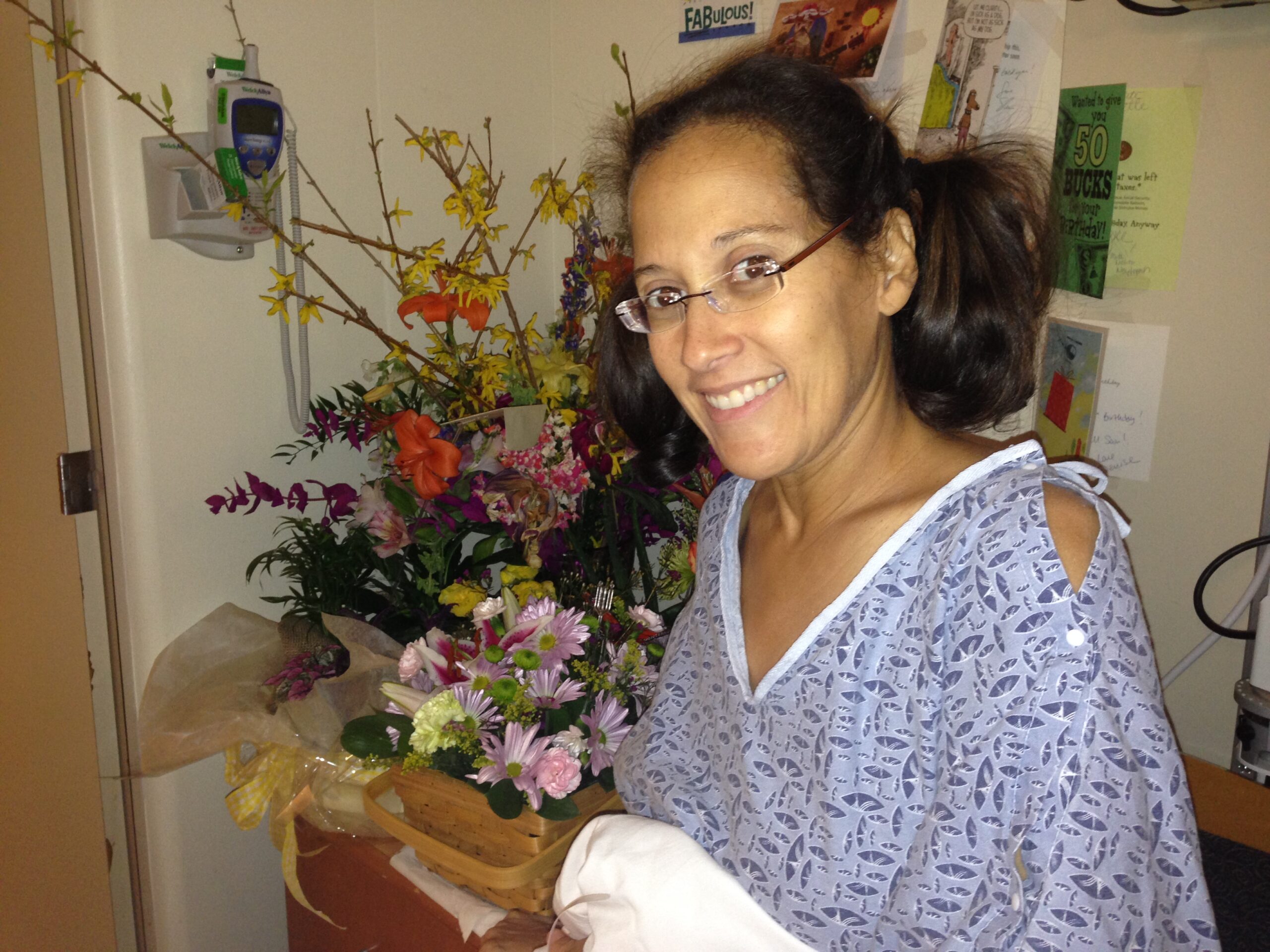 Dr. Yvette Colón in a hospital gown being treated for Pancreatic Cancer