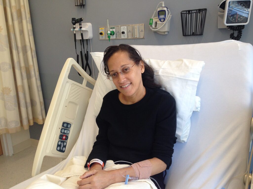 Dr. Yvette Colón sitting up in a hospital bed.