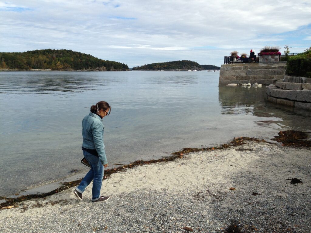 Dr. Yvette Colón walking the shoreline.